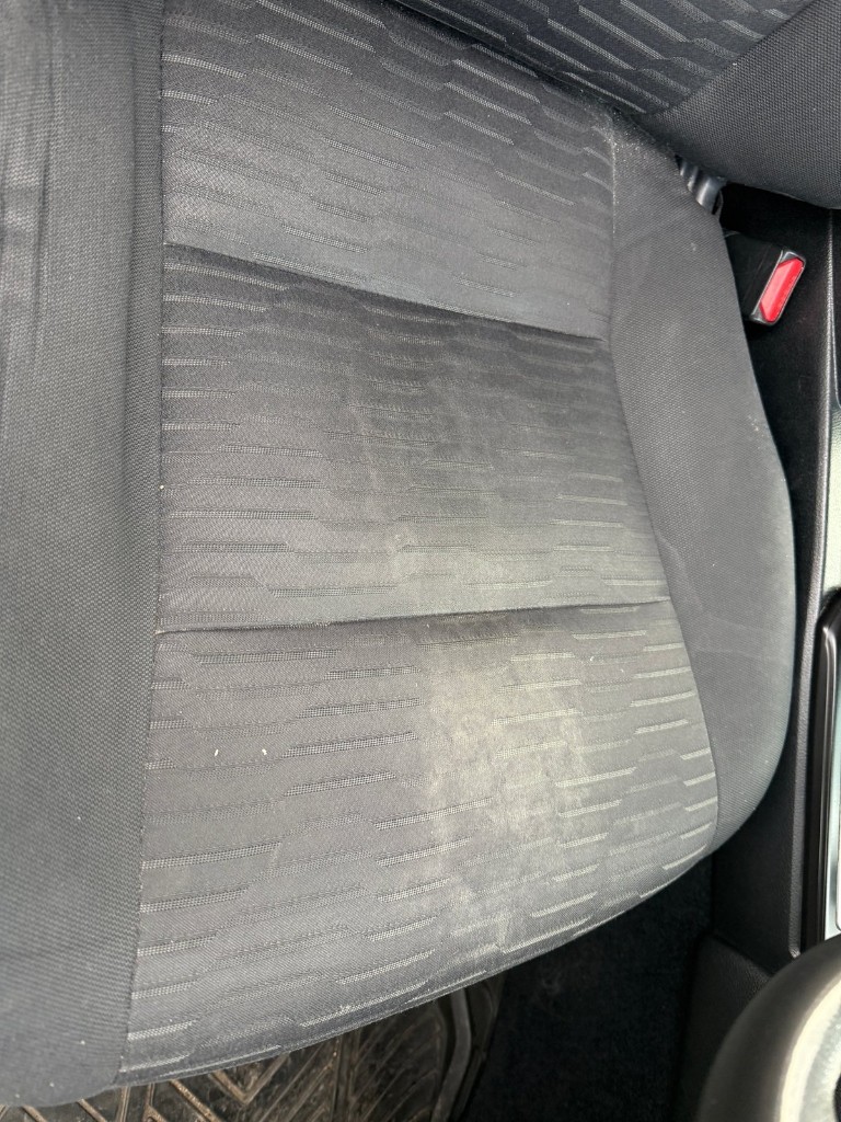 Soiled car seat fabric before deep steam extraction detailing by KP Auto Detailing